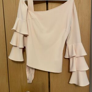 Peach off the shoulder at symmetrical top great with a pair of ripped jeans